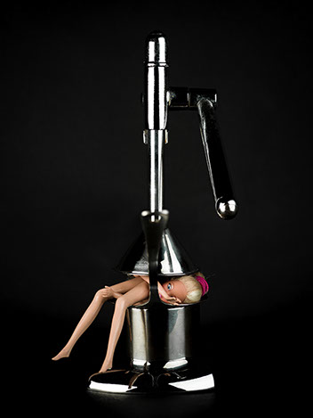 creative picture of Barbie pressed by a juicer shot in studio Halet with a Mamiya medium format digital back Phase One
