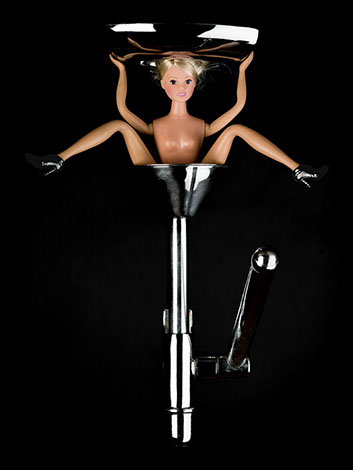 picture of Barbie pressed by a cooking utensil shot in studio Halet with a Mamiya medium format digital back Phase One