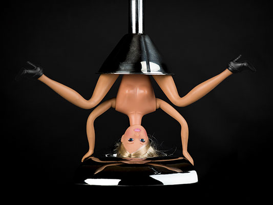 creative picture of Barbie pressed by a juicer shot in studio Halet with a Mamiya medium format digital back Phase One