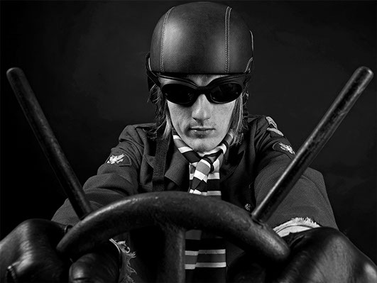black and white portrait of a model wearing a leather helmet and pretending to drive a car with racing goggles copyright Claude HALET
