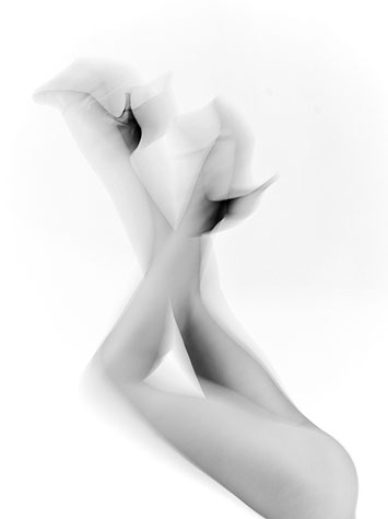 Naked and blurred female legs in the air feet are shod with high heels on white background shot in studio Halet with a Mamiya medium format